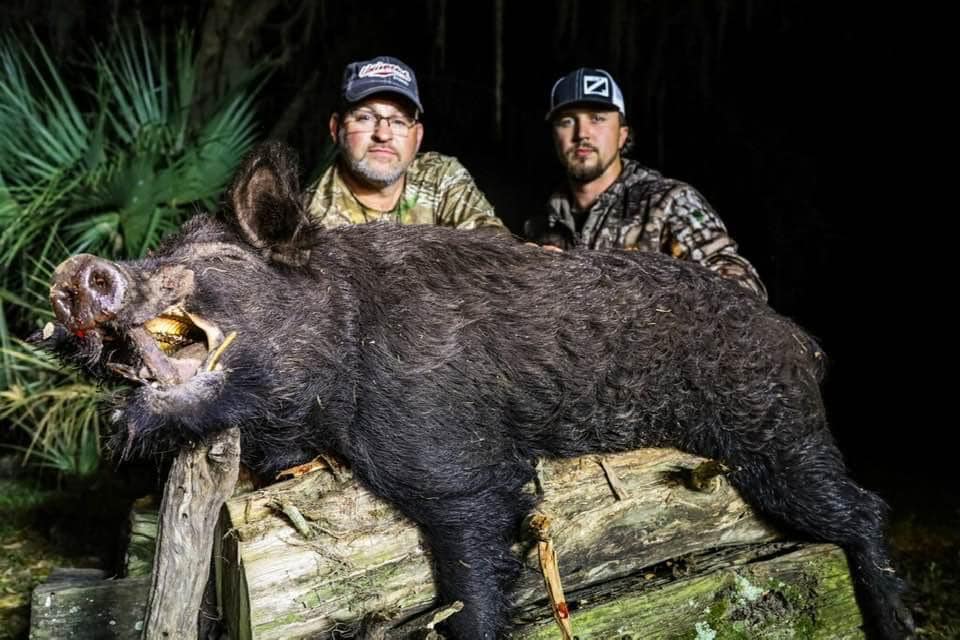 Osceola hunters in Florida with hunting guide, shown with two successful harvests. 