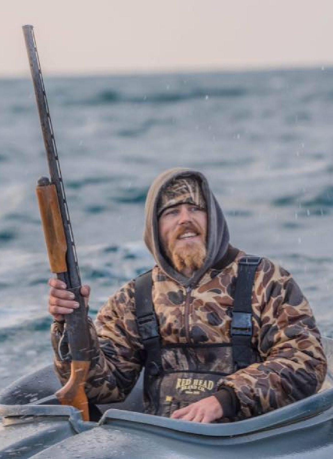 Waterfowl States - Michigan (2) Hunter standing over decoys in Perry, Oklahoma.