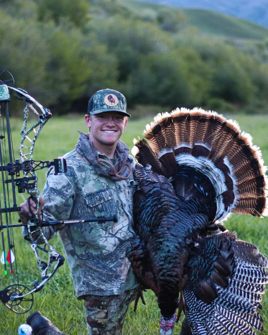 Bow hunter shown with turkey after a successful Spring turkey hunt in the Pacific Northwest, either Idaho or Washington state.